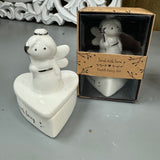 Cute White ceramic Fairy holding a silver wand in a heart shape pot
Quote on the heart pot base 'Tooth Fairy' 
Send with love Gift box 