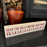 Wooden hanging / standing long Christmas Sign L40cm fun sign decorated in red glitter text; 
'Deck the Halls and not your Family Fa La La La La La La La La' 