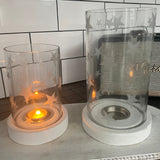 Whitewashed mango wood base with a Glass Hurricane with frosted scattered star detail Available in 2 sizes - Small H17.5cm & Large H23cm
