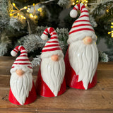 Christmas Ceramic Santa with a Red body, red & white stripped scarf and a long white beard & button nose 
Available in 3 sizes; Small 9cm, Medium 12cm & Large 17.5cm