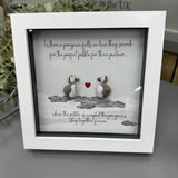 Pebble Art by La De Da Living 
Award winning keepsake gifts - Handmade in the Cotswolds 
Framed Pebble Art - Midi White block square frame 17.5cm
'When a penguin falls in love they search for the perfect pebble for their partner, when the pebble is accepted the penguins stay together forever '