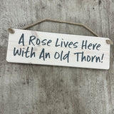Wooden Hanging Sign - "A rose lives here with an old thorn!"