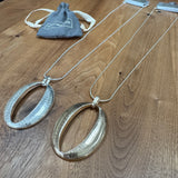 Eliza Gracious quality affordable design led branded costume jewellery
Long snake chain Necklace with a brushed oval pendant. 
Available in Burnished Matt Silver & Pale Gold