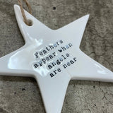 White ceramic hanging star 8.5cm with sentimental quote; 'Feathers appear when angels are near'