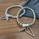Eliza Gracious quality affordable design led branded costume jewellery 
Stretch ball bead bracelet with twin heart charms 
Available in Matt Burnished Silver & Pale Gold  EB0511