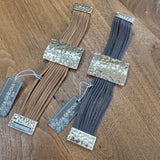 Eliza Gracious quality - affordable design led branded costume jewellery.
Multi stranded suede Bracelet with a beaten pale gold effect magnetic fastener and bar 3.5x5cm detail 
Available in Beige/tan or Dark Grey