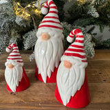 Christmas Ceramic Santa with a Red body, red & white stripped scarf and a long white beard & button nose 
Available in 3 sizes; Small 9cm, Medium 12cm & Large 17.5cm