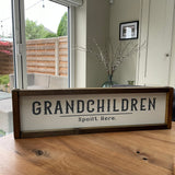 Made in the UK by The Giggle Gift Co.   Long 63.5cm Rectangular Framed Plaque with White vinyl; Grandchildren spoilt here