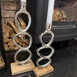 Minimal Brushed Chrome effect Candle stand with quirky oval details 
Available in 2 sizes; Small 25cm & Large 35cm