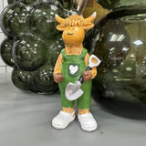 Standing H12cm Harry the Highland Cow Figure wearing green dungarees & white crocs, holding a Shovel 