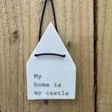 Radar Poetry - White Porcelain Glazed House shape 12x7cm hanging decoration  
Quote in a soft grey text - 'My home is my castle' with a leather thong detail