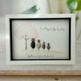 Framed Pebble Art - White block frame 31.5cmWith a soft background image of a Tree with the leaves being pink hearts blowing in the wind and 4 pebble people - 2 adults & 2 children holding hands with the quote 'Our Perfect Little Family... Together is our favourite place to be'