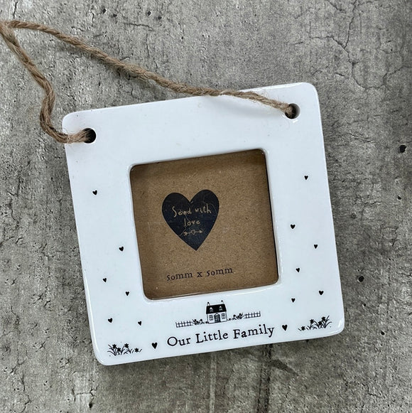 Beautiful white ceramic photo frame with heart detailing up the sides and a cute house illustration. In the middle is space for a small photo with quote 