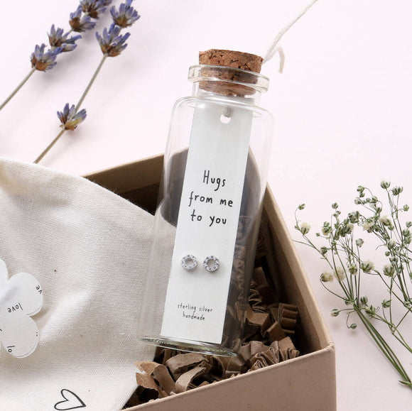 Attic Creations - giftings life's precious moments since 2010;    Message in a Bottle Sterling Silver Earrings handmade in Devon Style - Silver & Gold sparkly cirlce stud earrings Quote on the card - 'Hugs From Me to You'