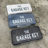 Made in the UK by Giggle Gift Co. Wooden block keyring with white text quote on both sides; 'The Garage Key'
