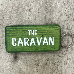 Made in the UK by Giggle Gift Co. Wooden block keyring with white text quote on both sides; 'The Caravan' 
