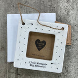 Beautiful white ceramic photo frame with star detailing all around. In the middle is space for a small photo with quote "Little Moments, Big Memories" written underneath. Hung with a jute rope.