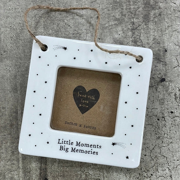 Beautiful white ceramic photo frame with star detailing all around. In the middle is space for a small photo with quote 