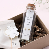Sweet twinkle shaped earrings presented in a message bottle on a lovely card that reads "may your dreams come true"