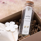 Attic Creations - giftings life's precious moments since 2010;    Message in a Bottle Sterling Silver Earrings handmade in Devon Style - Silver & Gold heart stud earrings Quote on the card - 'Bottled with love'