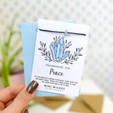 Mini Wishes by Molly & Izzie Black cord bracelet with a real crystal chip bead presented on a card with the quote; 'Aquamarine for Peace'