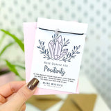 Mini Wishes by Molly & Izzie Black cord bracelet with a real crystal chip bead presented on a card with the quote; 'Rose Quartz for Positivity'