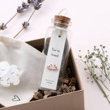 Sweet heart shaped stud earrings presented in a message bottle on a card that reads "you're loved"  Sterling Silver