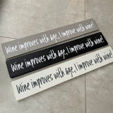 Long Wooden Hanging Plaque;  Wine improves with age, I improve with wine!   Made in the UK by The Giggle Gift co.