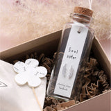 Sweet feather shaped stud earrings presented in a message bottle on a card that reads "soul sister"  Sterling Silver