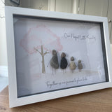 Framed Pebble Art - White block frame 31.5cmWith a soft background image of a Tree with the leaves being pink hearts blowing in the wind and 4 pebble people - 2 adults & 2 children holding hands with the quote 'Our Perfect Little Family... Together is our favourite place to be'