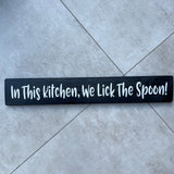 Long Wooden Hanging Sign - 'In This Kitchen, We Lick The Spoon!'