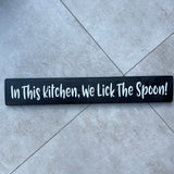 Long Wooden Hanging Sign - 'In This Kitchen, We Lick The Spoon!'
