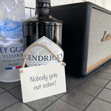 Mini Metal Hanging Sign with fun quote:  "Nobody Gets Out Sober" 9cm