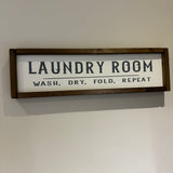 Made in the UK by Giggle Gift co.
Rectangular L64cm Framed Plaque with Old White vinyl;
"Laundry Room Wash, Dry, Fold, Repeat"