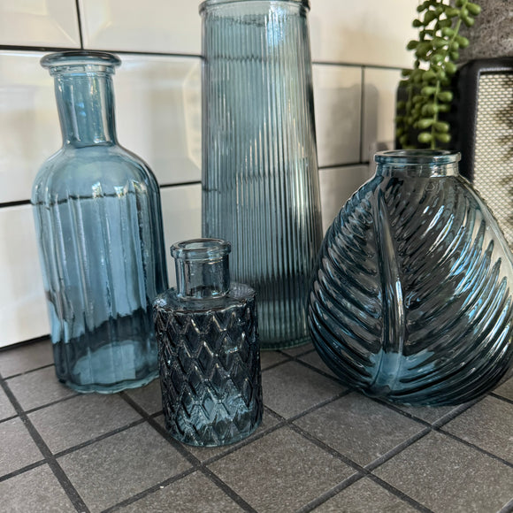 Blue Small Glass Bottle Vases
Various styles
Small Geometric Bottle H9.2cm x 5cm

Leaf bottle Vase H13cm 
Tall Slim Ribbed Vase H22.5 x Dia 10cm
Round Ribbed H8.4 x Dia8.3cm