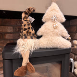 Shelf sitting plush Gonk with a tall leopard print faux fur hat, long off-white beard, and long soft dangling legs with brown corduroy boots 45cm.