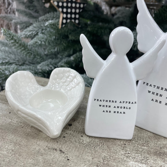 White ceramic standing angel ornament with the sentimental quote: 'Feathers appear when angels are near' Available in 2 sizes; Small 11.5cm and Large 15cm 