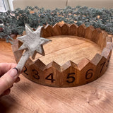Decorative round wooden advent countdown tray 29cm; features carved numbered sections and a metal star marker to move on daily..&nbsp;
