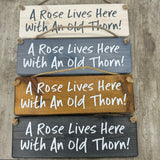 Wooden Hanging Sign - "A rose lives here with an old thorn!"