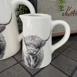 White glazed Ceramic Jugs with a black classy pencil illustration of Highland Cows

Small 11cm &amp; Large 16cm