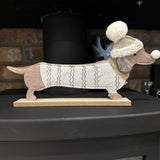 Sausage dog / Dachshund long felt dog ornament on a wooden base
Dog is wearing a jumper and hat in brown &amp; beige colours L30cm&nbsp;