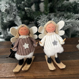 Fabric Standing skiing Angel 11cm wearing a cosy knit jumper dress with soft felt wings featuring wooden skis and ski poles
Available in 2 colours;&nbsp; White &amp; Brown&nbsp;&nbsp;