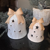 Neutral glazed Ceramic LED detailed Bell with a rough textured bow on the top and lots of open stars &amp; circles to let the light through when switched on..
Available in 2 sizes - Small H9cm &amp; Large H13cm