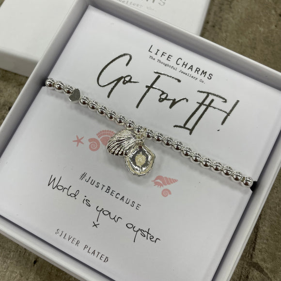 Life Charms the Thoughtful Jewellery Co. Just Because Bracelet Collection; Go For It! World is your oyster x Pure silver plated with cute hanging oyster shell charm that opens to reveal a pearl inside, presented on a 5mm beaded stretch bracelet. 