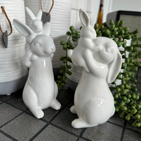 White Ceramic Family Rabbits H16.5cm - 2 styles Mum Rabbit holding baby rabbit up and kissing Dad Rabbit carrying baby rabbit on his back