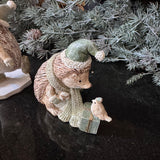 Festive charming Hedgehog wearing a sage scarf and gift box with a bird perched on it wearing matching sage santa hats H9cm&nbsp;