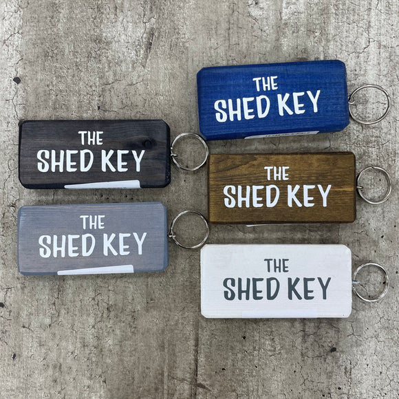 Made in the UK by Giggle Gift Co. Wooden block keyring 10cm with white text quote on both sides; 'The Shed Key' 