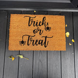 Natural Coir Doormat 40x60cm with the following quote;
'Trick or Treat' with spiders hanging from the letter T's