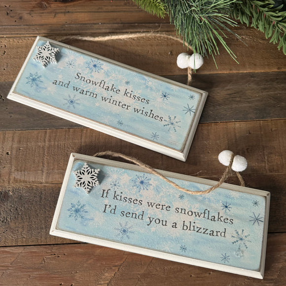 Wooden hanging Snowflake signs with a blue frosted glitter look 20cm 
Available in two quotes;
Snowflake kisses and warm winter wishes
If kisses were snowflakes I'd send you a blizzard