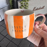 Belly Button Designs - Mabel Range
Stoneware Mug 340ml hand-painted wide, orange &amp; white vertical stripes
Text stamped on the front - Lovely Friend&nbsp;